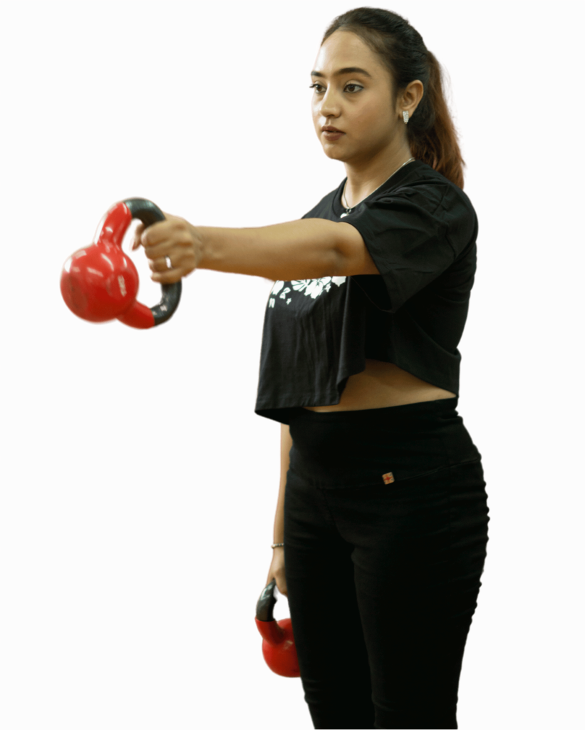 A person in a black outfit performs a kettlebell exercise with red kettlebells against a plain brown background.